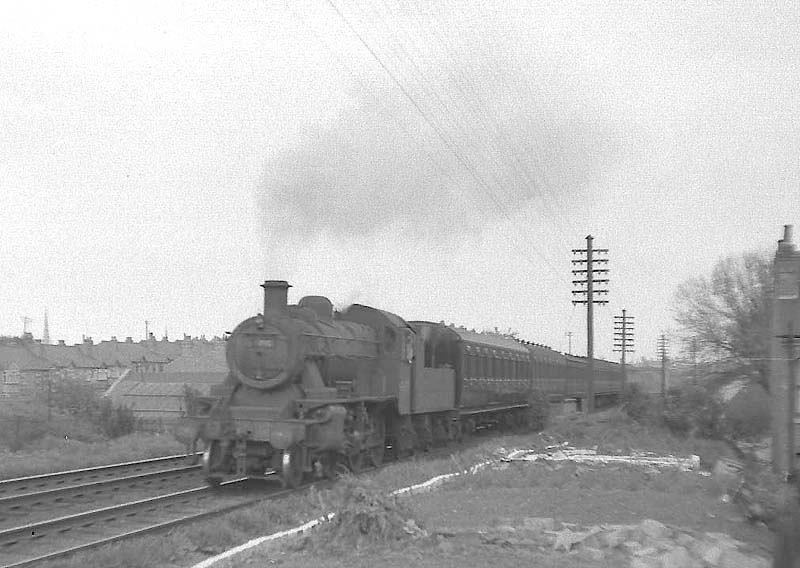 An unidentified ex-LMS 2-6-0 2MT Ivatt Mogul is seen on a Nuneaton to Leamington local passenger service as it crosses Albany Road bridge in Earlsdon