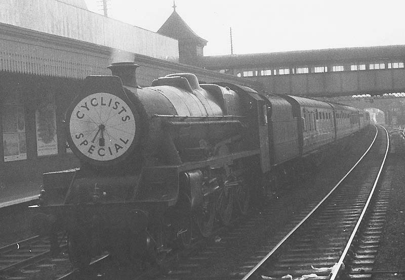 An unknown ex-LMS 4-6-0 Jubilee class locomotive is seen at the head of a cyclists special train running wrong road through Coventry station