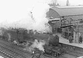 An unidentified ex-LMS 4-6-0 Stanier 'Black 5' is seen at the head of a mineral train as it passes through Coventry during the early stages of reconstruction