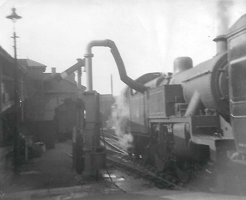 The L&BR column being used to top up the tanks of an unidentified Fowler 2-6-4T locomotive on a Rugby to Birmingham train in 1957