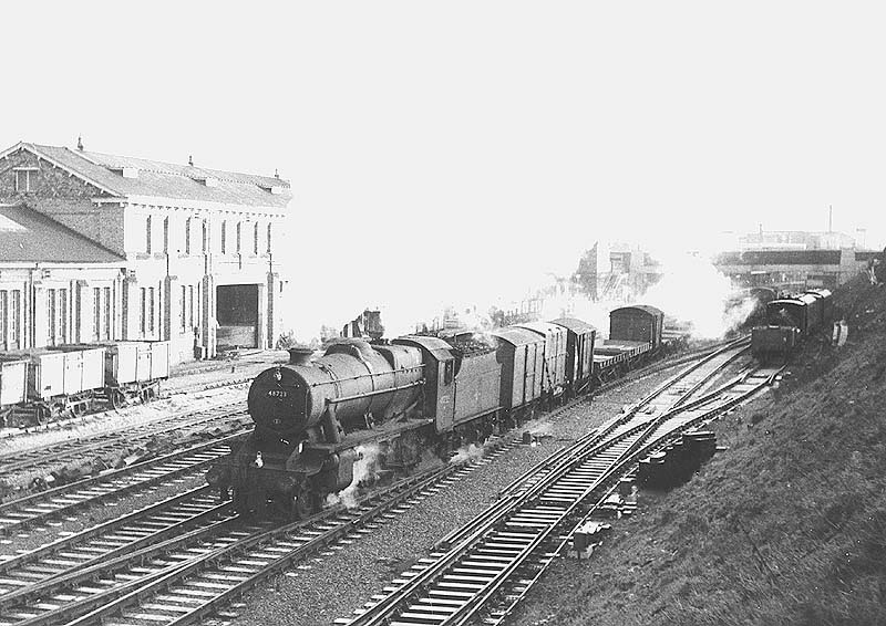 Ex-LMS 2-8-0 8F No 48723 is seen crossing over on to the Nuneaton lines at the head of a down mixed freight service