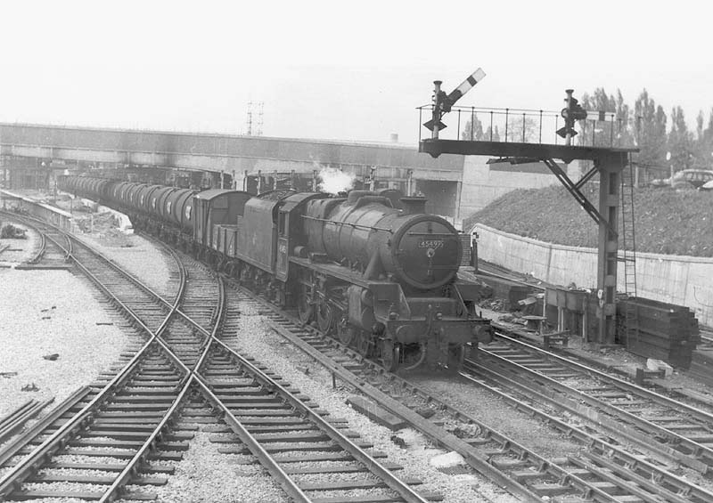 Ex-LMS 4-6-0 Black 5 No 45495 is seen on an up empty oil train passing by the half-built new platform two on its way south to the docks