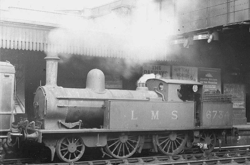 Ex-LNWR 1P 2-4-2T No 6734 is seen standing at Platform 1 at the head of a Nuneaton to Leamington local passenger train