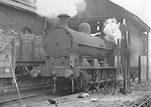 Ex-LNWR G2 Class 0-8-0 No 49425 stands inside Coventry shed's  'Coal Hole' being serviced in 1953