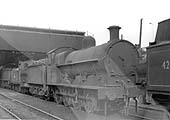 A very grimy ex-LNWR 0-8-0 7F 'Super D' is seen standing in line with an unknown ex-LMS 0-4-4T behind its tender