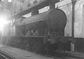 An unidentified ex-LNWR 0-8-0 7F 'Super D' locomotive is seen standing cold inside of Coventry's new shed on a Sunday