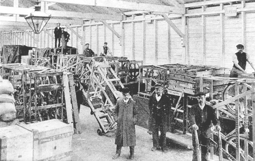 View of a rake of open wagons being loaded with crates of Triumph cycles inside Coventry No 2 goods shed