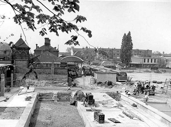 View of the foundations being laid to the new parcels depot and buffer stops to the three platforms and with the old station in the background