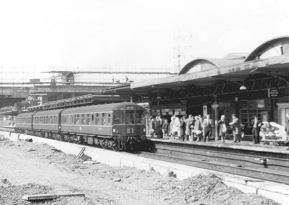 A three car DMU stands at Coventry's up platform which still retains some of the original structure
