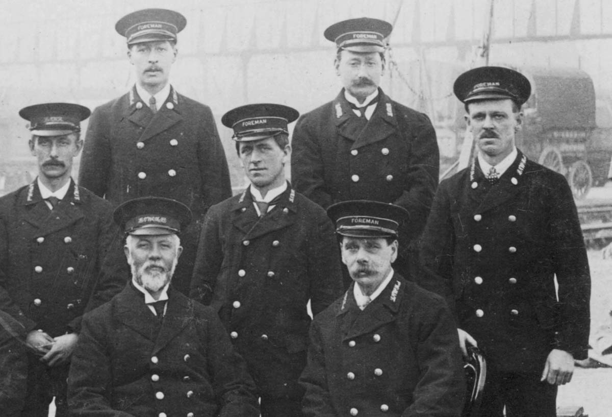 Close up of the group photograph showing John James King and five other colleagues, together showing three different hatbands