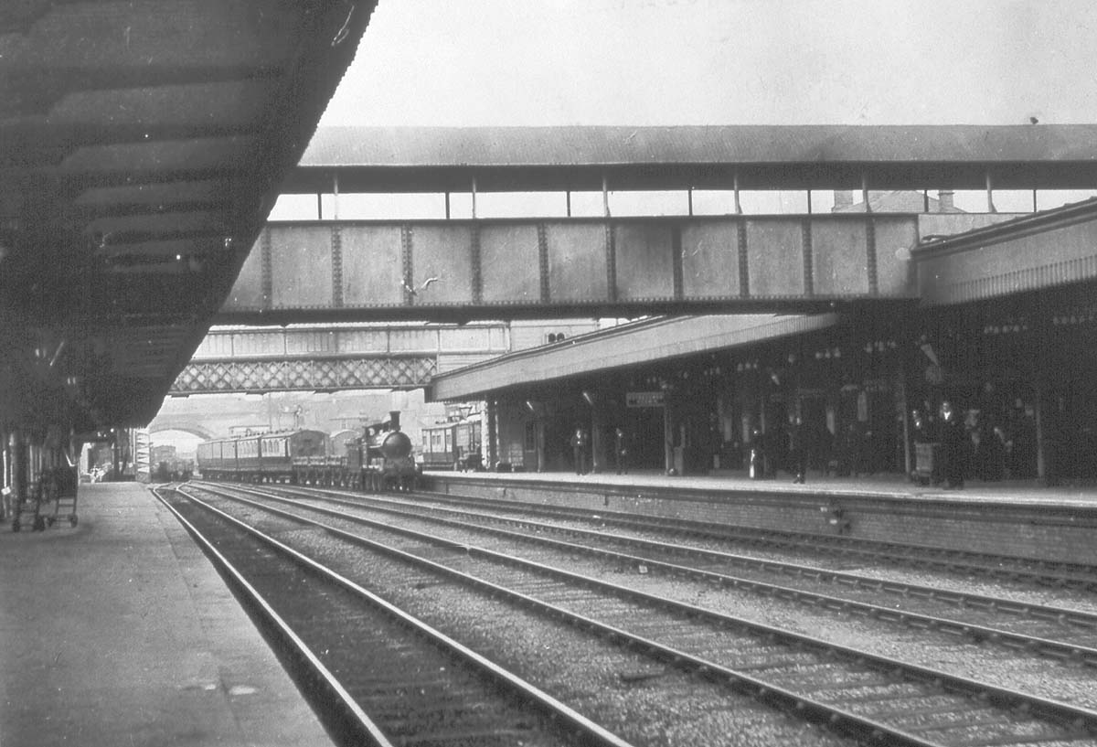 View looking towards Birmingham of Coventry's fourth station as a LNWR 0-6-0 Cauliflower goods engine heads a passenger train in to the up platform