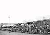 View of seven Hillman cars being transported to Coventry Goods yard by horse drawn trailers from the works