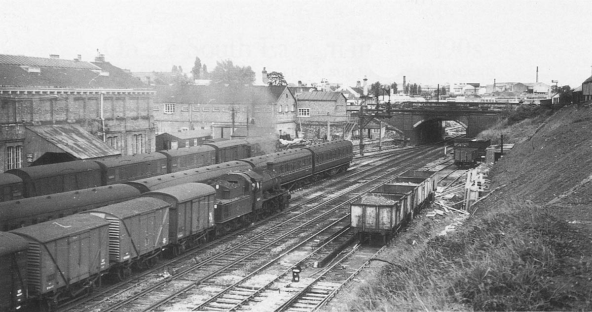 BR built 2-6-0 2MT No 46445 is seen hauling a train of vans as it approaches the up home signals controlled by Coventry No 2 Signal Cabin