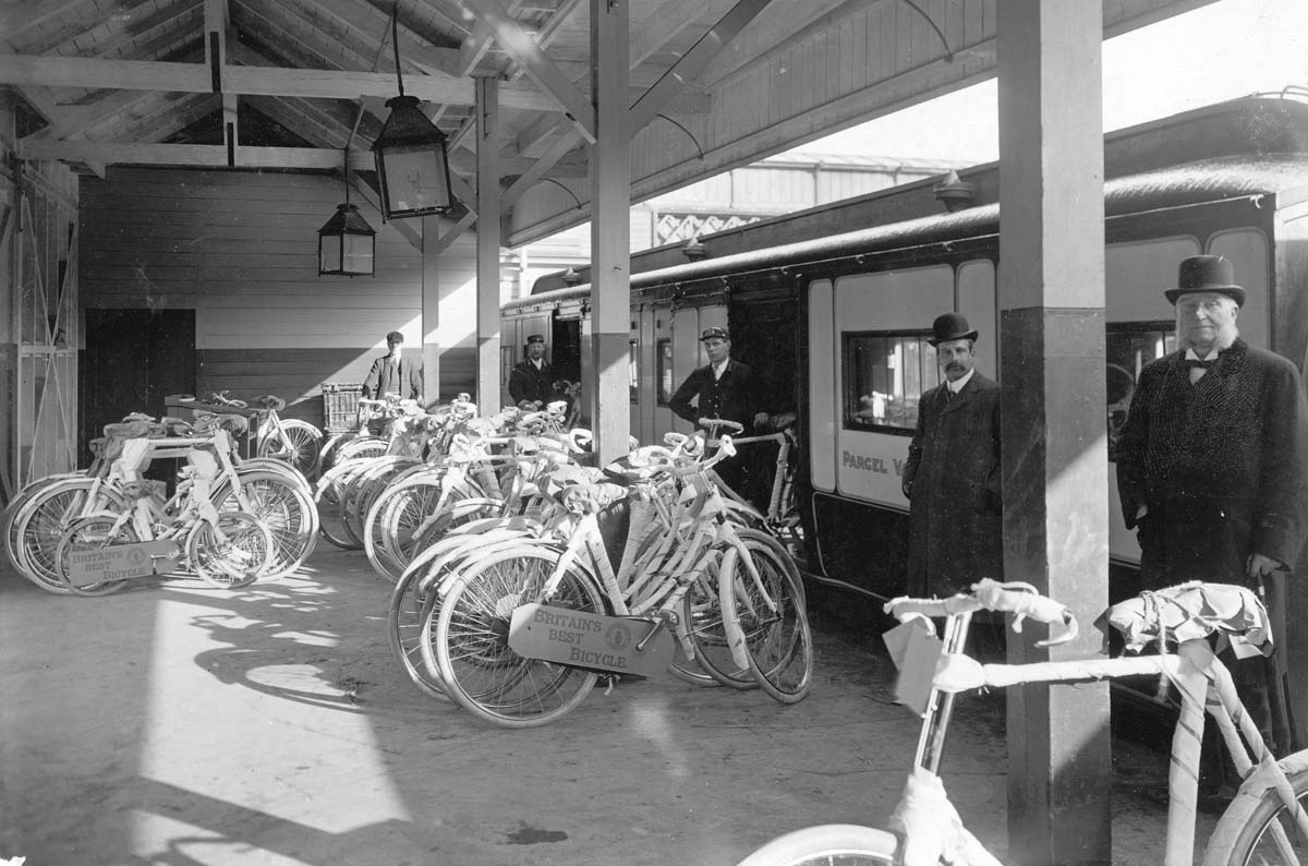 View of a Clerestory LNWR Parcels Van being loaded with a range of bicycles for dispatching via an express service
