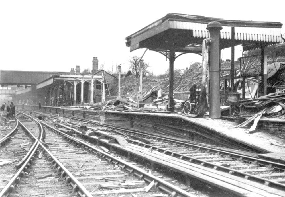 View of the damage sustained to the Rugby end of the up platform including bomb craters to the running line