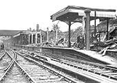 View of the damage sustained to the Rugby end of the up platform including bomb craters to the running line