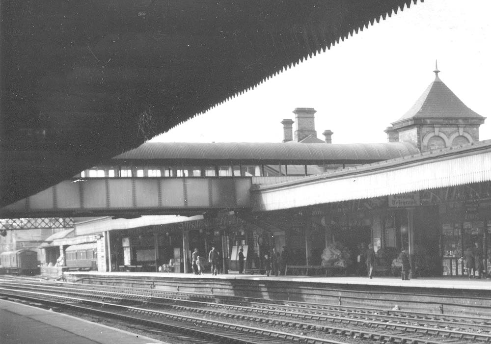 Close up showing the up platform concourse and the luggage bridge with the passenger footbridge just visible behind