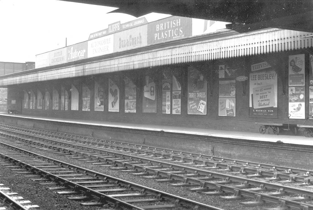 View showing the long retaining wall covered in advertising posters that ran from the parcels bridge to Stoney Road bridge