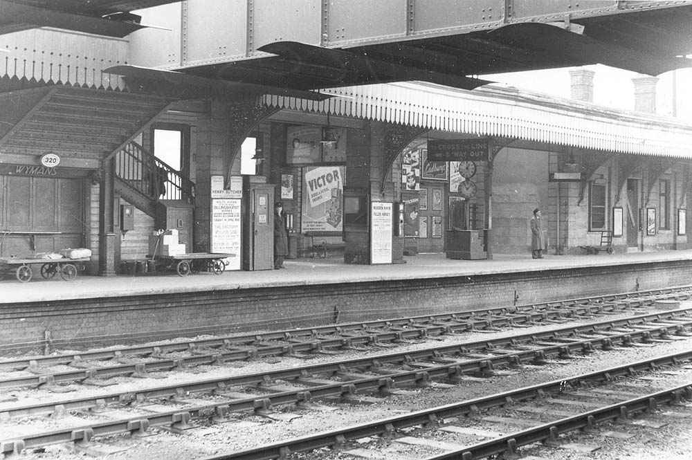 View of the down platform showing the passenger footbridge and the Wymans the newsagent's booth underneath