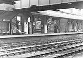 View of the down platform showing the passenger footbridge and the Wymans the newsagent's booth underneath