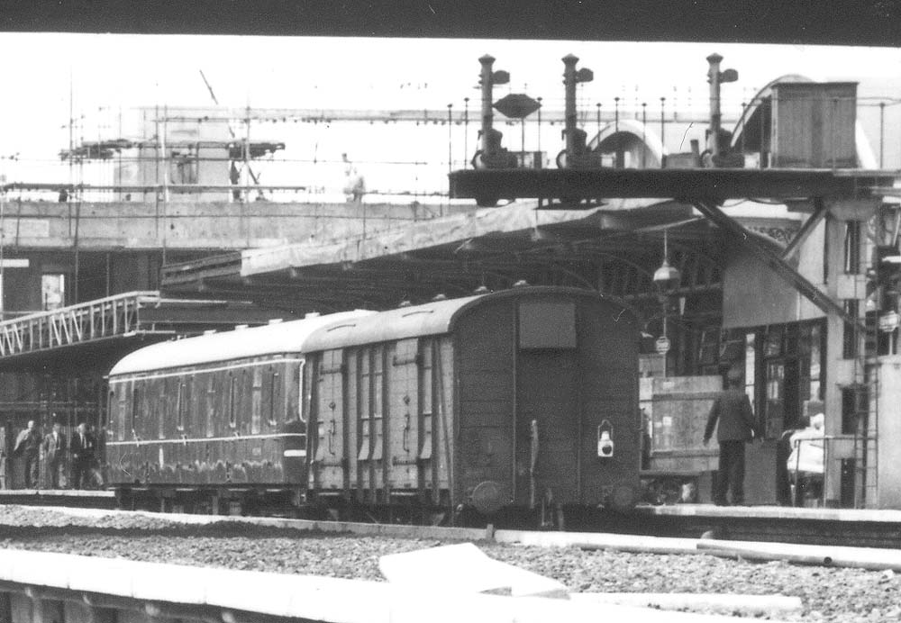 Close up of a single diesel railcar coupled to a long-wheel base van for transferring luggage and parcels between the Platforms One and Four