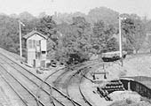 Close up showing the junction and signal box with open wagons loaded with ballast standing alongside the signal controlling access to the main line