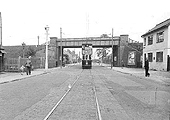 Looking along Stoney Stanton Road as a tram passes under Coventry Loop Line and in front of Bell Green goods yard which is on the left on 20th August 1939