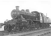 Ex-LNWR 7F 0-8-0 G2a class No 49164 is seen travelling on the down line and about to cross over on the loop line to Three Spires junction