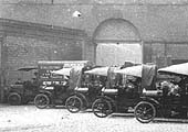 Close up showing the fleet of primarily light motor lorries together with a sole example of a lorry for medium loads
