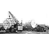 A special cargo of glass-lined metal tanks each weighing 4 tons is being unloaded by Banbury Street's mobile crane