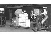 A Curzon Street deck gang transferring merchandise from the road vehicle unloading dock into a van