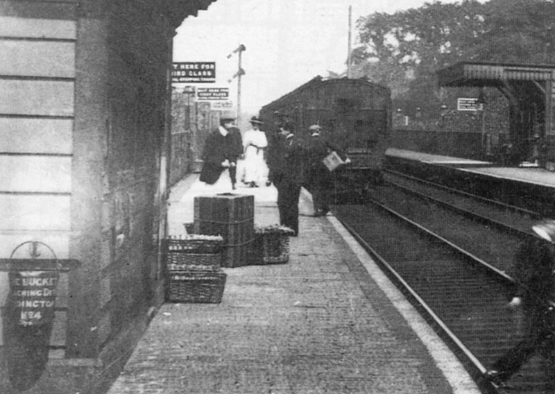 Close up showing passengers and parcel traffic standing on the up platform at Erdington Station