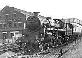 British Railways Standard Class 4MT 4-6-0 No 75063 passes Campton & Sons works as it approaches the station on a local service