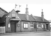View of Foleshill station's main passenger buildings, still in its LMS corporate livery, and dominated by the Lockhurst Lane road bridge