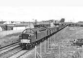 Looking towards Nuneaton as English Electric Type 4 No D339 passes the former site of Foleshill goods yard which has now been fenced off