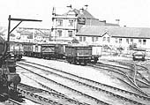 Close up showing a number of timber and steel wagons standing fully loaded with coal on most of Foleshill station's six sidings