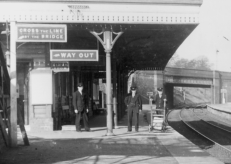 Close up showing some of Four Oaks' station master and other staff posed on the up platform circa 1951