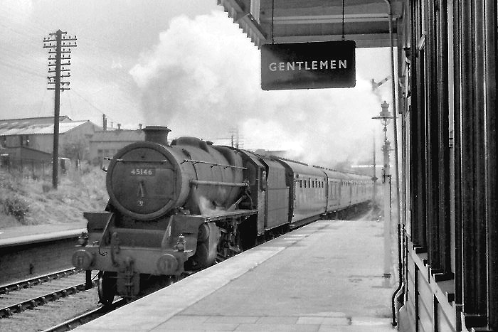 Ex-LMS 4-6-0 'Black Five' No 45146 is seen passing through the station on a down passenger service to Stafford