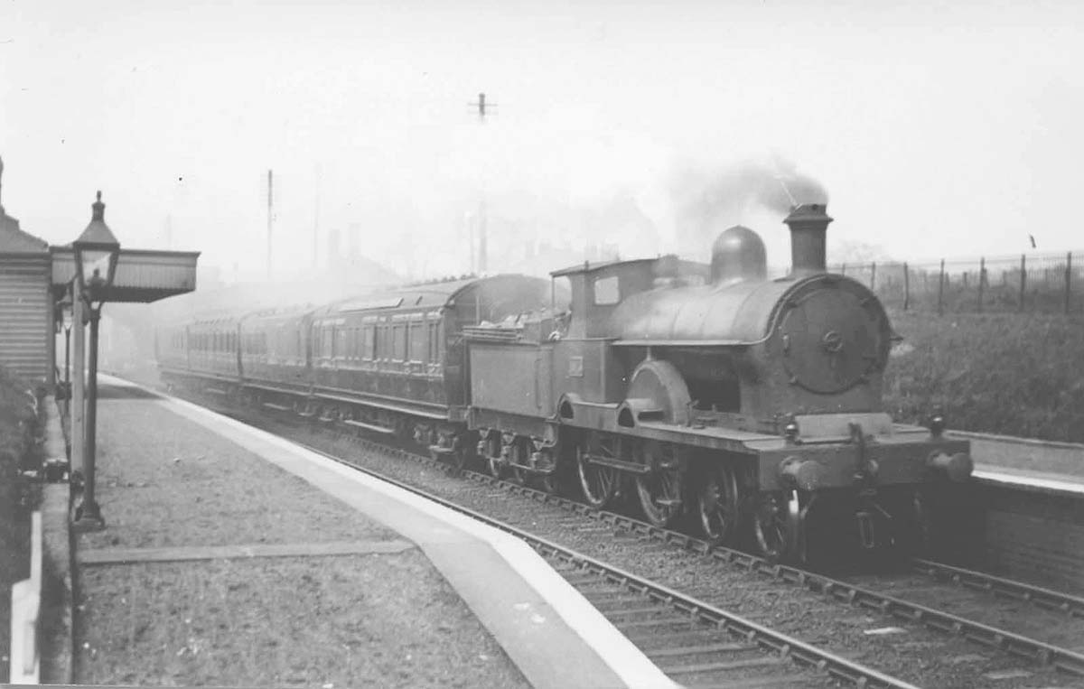 Ex-LNWR 4-4-0 No 1915 Renown Class 'Implacable' passes through Great Barr on an up passenger service circa 1923