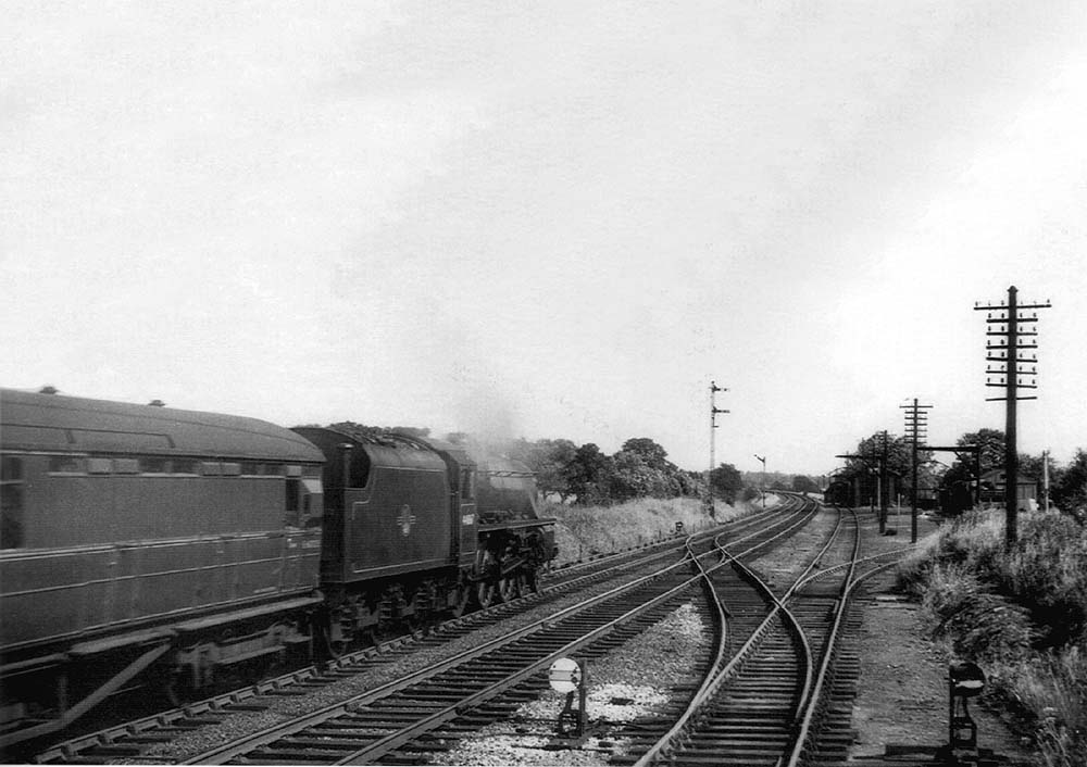 Ex-LMS 4-6-0 5MT No 44867 passes the goods yard on the 3:55pm Birmingham to Peterborough service on 27th June 1961