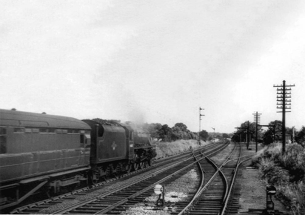 Ex-LMS 4-6-0 5MT No 44867 passes the goods yard on the 3:55pm Birmingham to Peterborough service on 27th June 1961