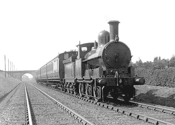 An unidentified LNWR 0-6-0 18" Goods Engine is seen working a local all stations passenger service near Hampton in Arden in July 1921