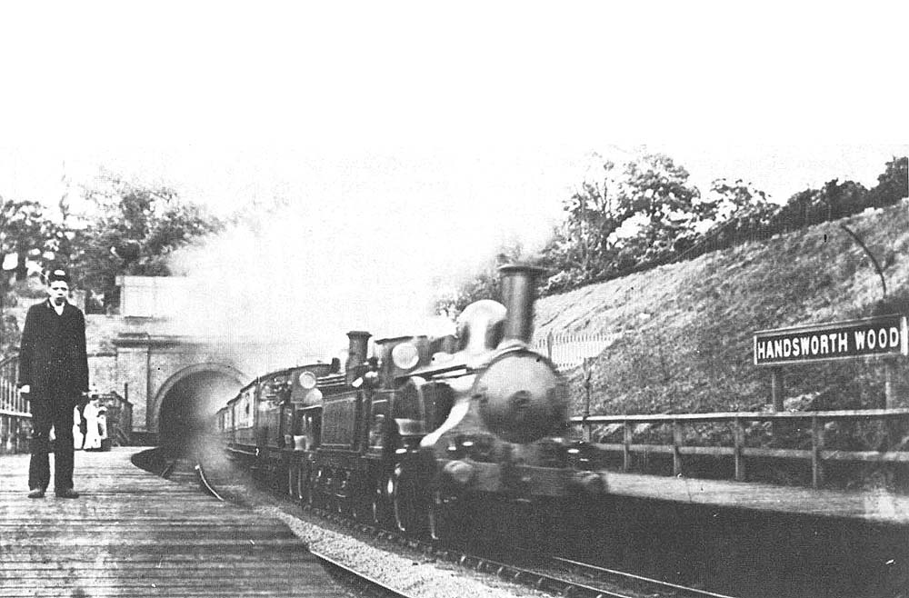 Two LNWR locomotives storm out of the tunnel whilst at the head of an up train to Birmingham New Street
