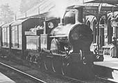 Close up of the immaculate unidentified LNWR 2-4-0 Improved Precedent class locomotive as it passes through Kenilworth station's down platform