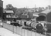 Close up of Kenilworth station's general goods yard and goods shed with an assortment of mineral wagons and oil tankers in the yard