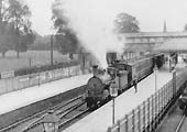 An unidentified LNWR 0-6-0 'Coal Engine' is seen standing at the down platform at the head of a local passenger service to Coventry