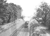 An unidentified ex-LNWR tank engine has just passed under Leamington Road bridge as it heads a local passenger service to Coventry