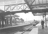 View of Kenilworth station as an unidentified LNWR 2-4-2T tank engine brings a local passenger service to a halt at the up platform