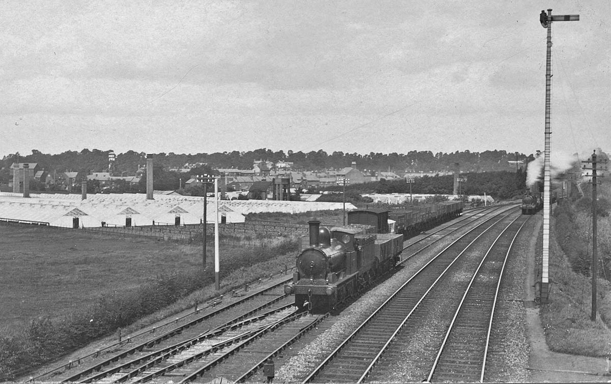 An unidentified LNWR 0-6-0 18 inch Coal engineis is approaching the tall signal on the right