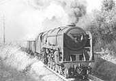 British Railways Standard Class 9F No 92128 is throwing unburned coal whilst working an up mineral train towards Kenilworth Junction